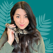Emzotic holding a ball python